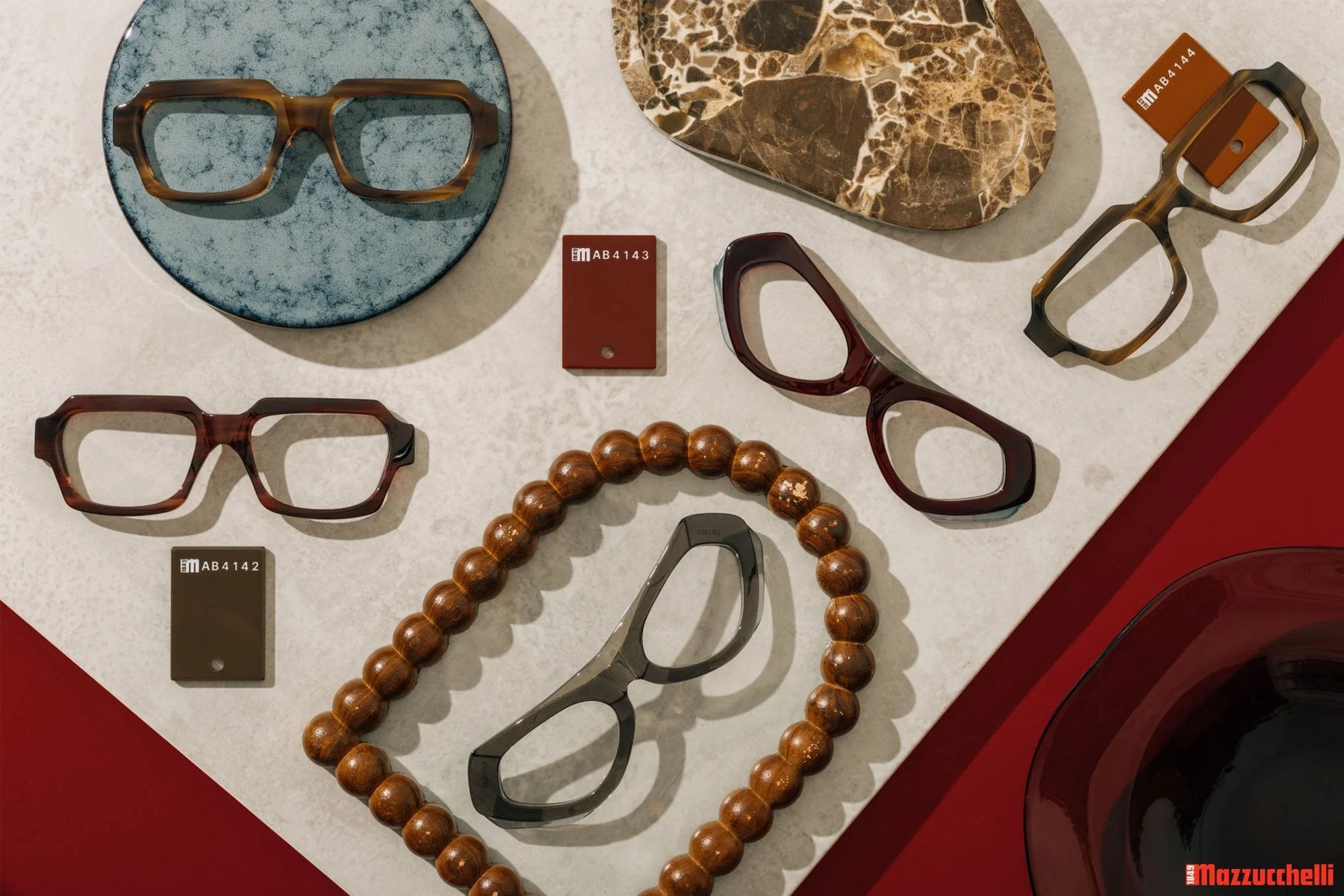 Acetate frames and Mazzucchelli acetate swatches arranged on stone